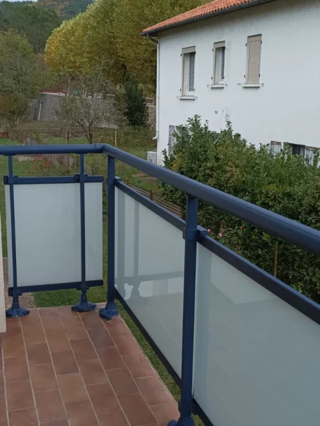 Détail du garde-corps vitré aluminium bleu sur le balcon dans le Gard